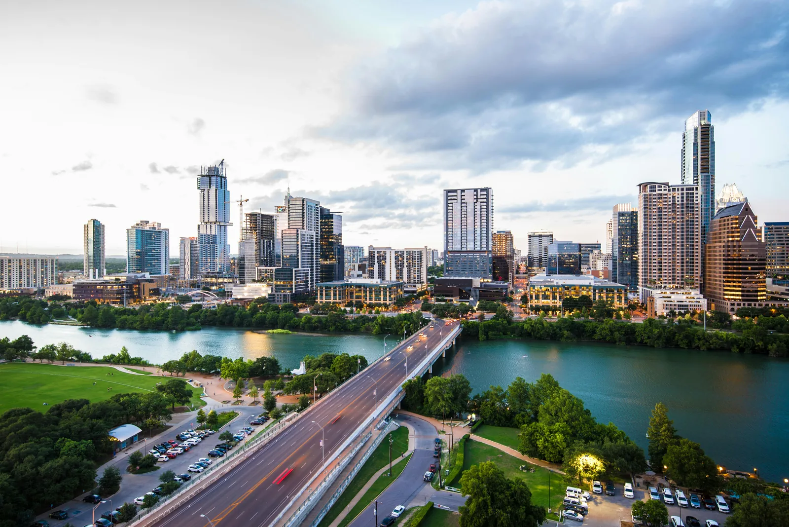 Aerial view of the downtown Austin, Texas skyline at dusk over Lady Bird Lake