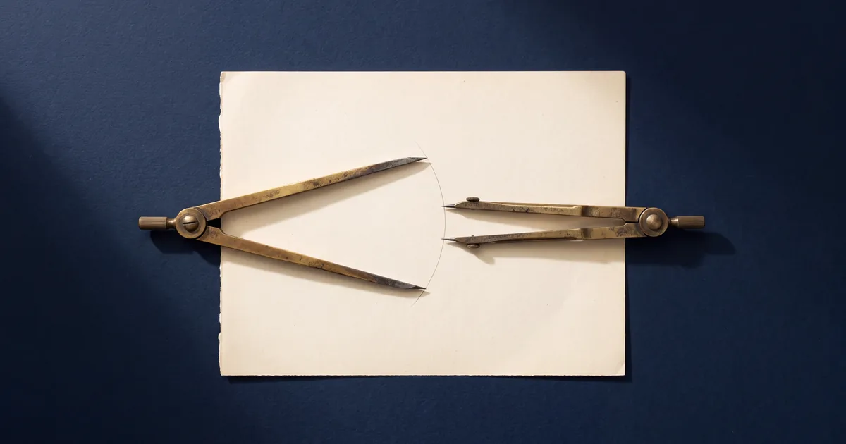 Two antique brass drafting dividers resting on a cream sheet of paper on a deep navy surface, each opened to a different angle with its points meeting the same faint arc drawn on the page